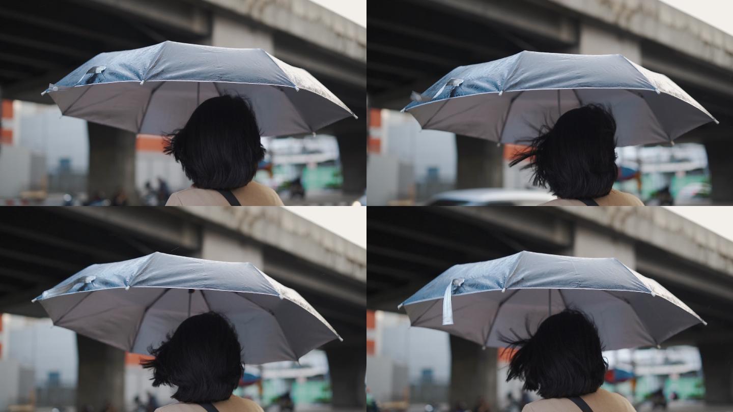 亚洲女子在雨中等出租车