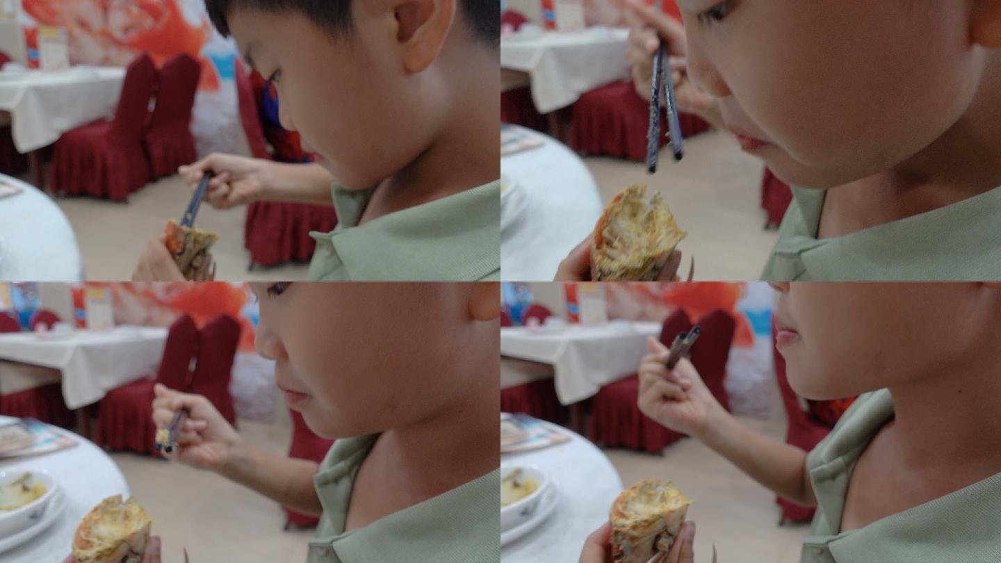 可爱的男孩用黄油吃螃蟹