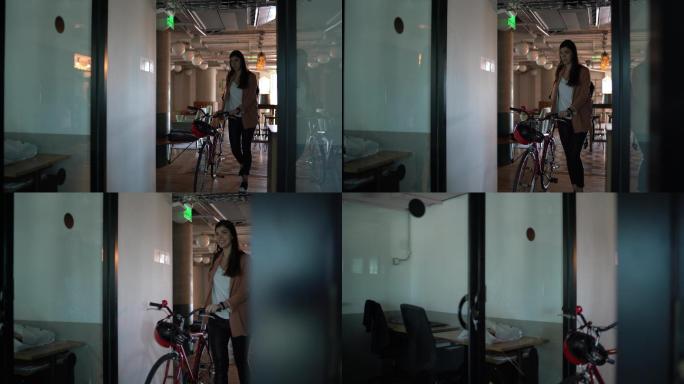 年轻女商人在现代办公室骑自行车