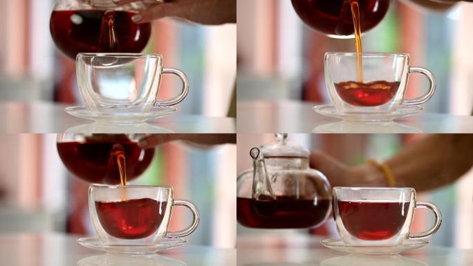 特写将热的草药茶倒入玻璃茶杯