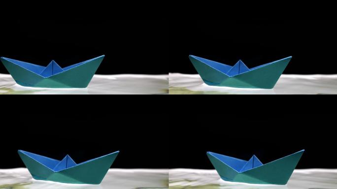 蓝色纸船，在水上折纸小船纸船漂浮在水面上