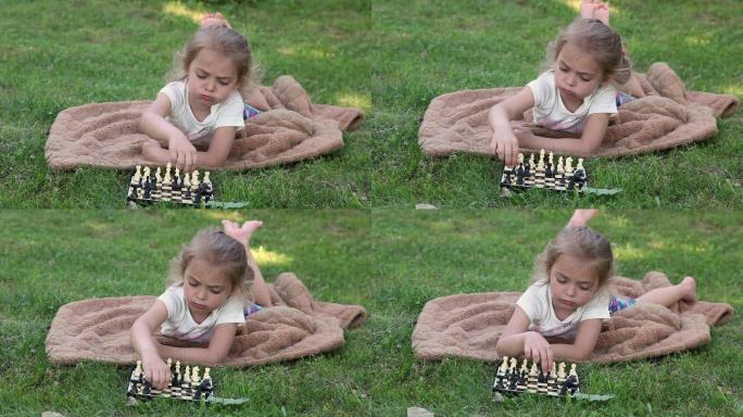 焦虑的小女孩在公园的棋盘上摆好棋子