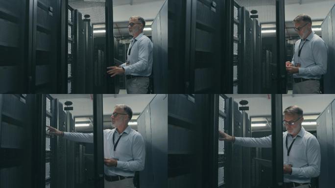 一名成熟技术人员在服务器机房执行维护检查时使用数字平板电脑的4k视频片段