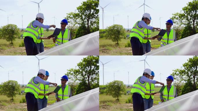 蓝领工人电气工程师团队和建筑师持有风车场和太阳能电池板施工的咨询计划。景观设计使用风力涡轮机来产生纯