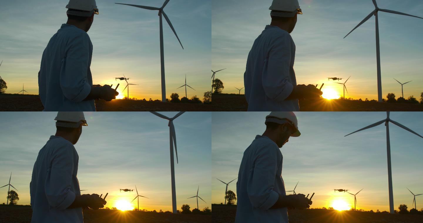 年轻男性工程师控制着在风力发电站工作的无人机，检查风力发电厂的能源生产。可再生能源工厂概念。