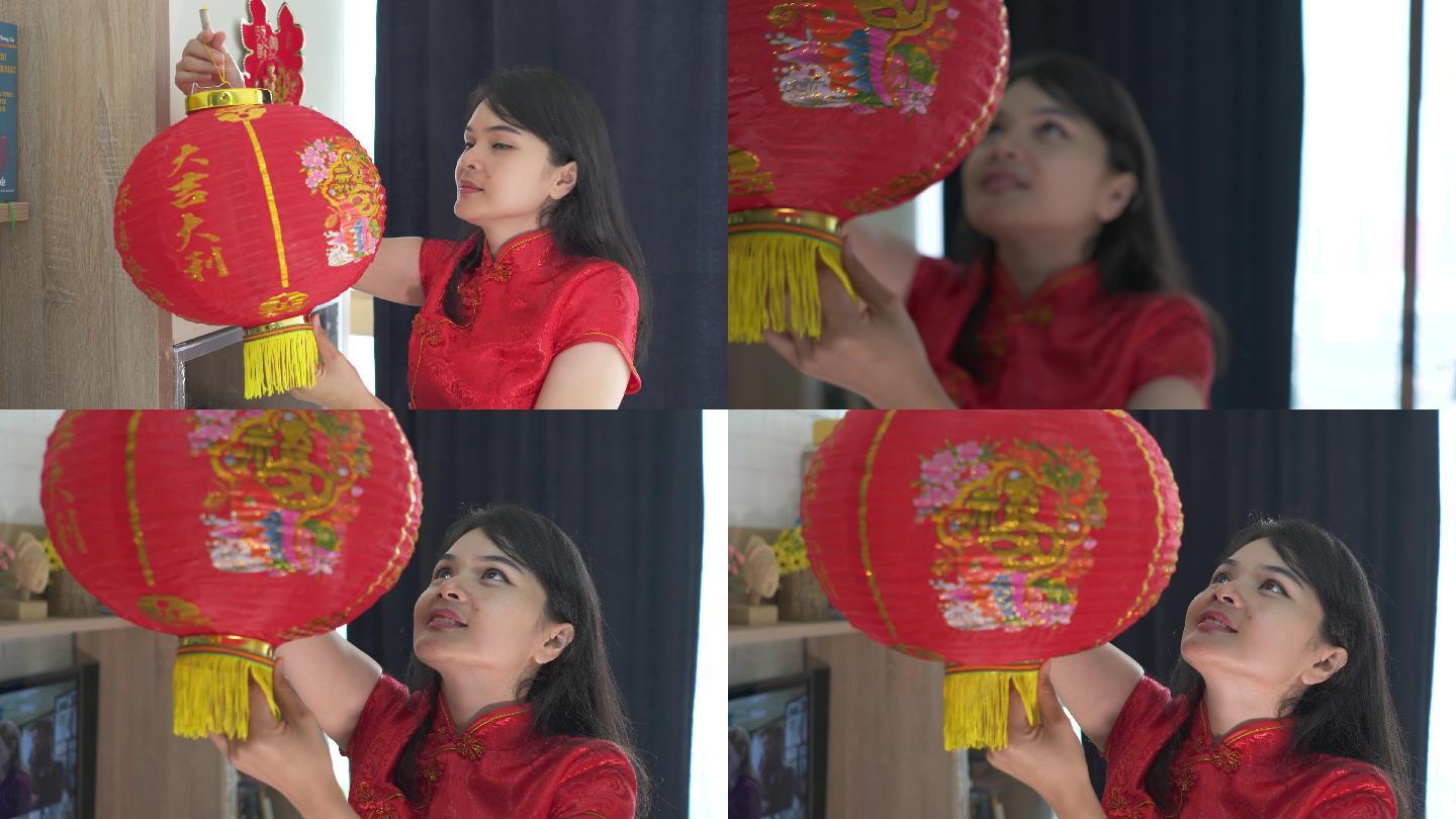美丽的亚洲年轻女子为中国新年装饰她的房子