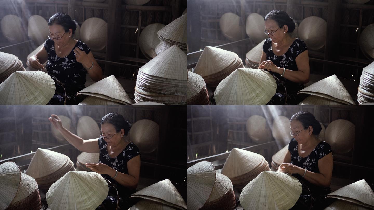 4k镜头的低光场景，老越南工匠在越南Cantho省Ap Thoi Phuoc村的老传统房子里制作传统