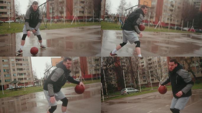 专注的年轻运动员，展示他的运球技巧，在潮湿的篮球场上滑倒