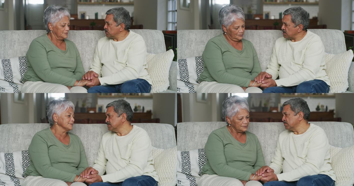 4k视频片段，一名老年男子与妻子坐在家中的沙发上安慰她