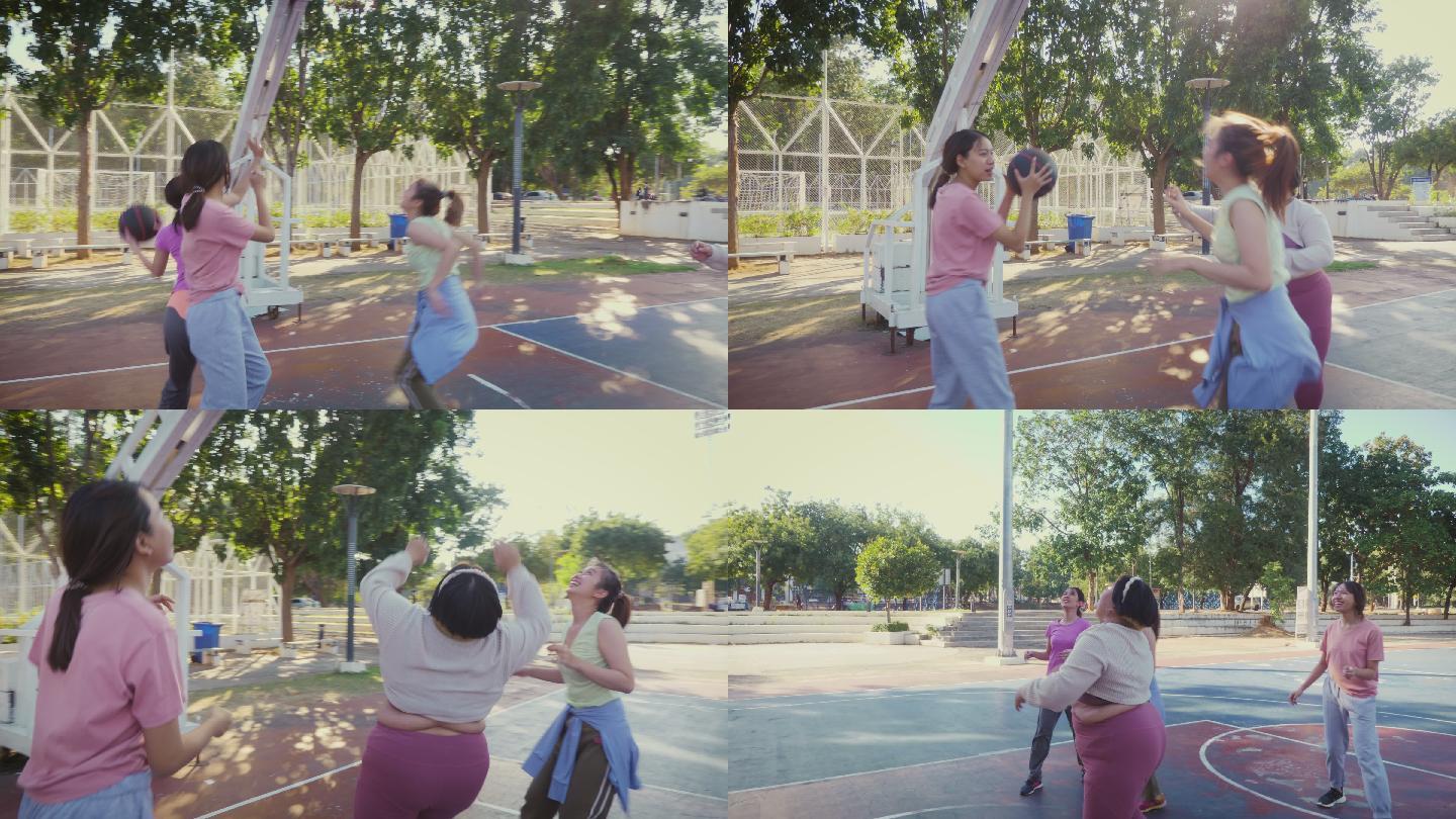 一小群年轻的亚洲女性朋友喜欢在户外球场上打篮球
