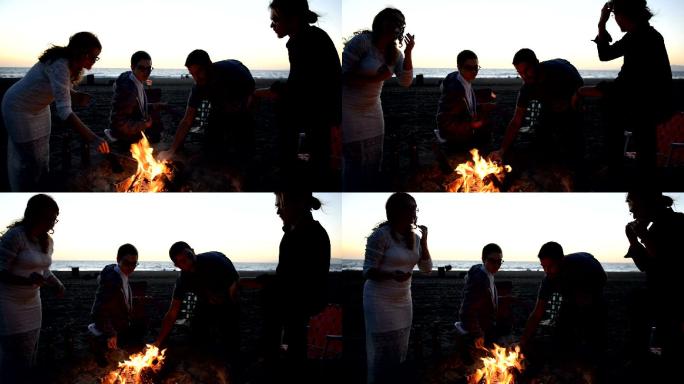朋友们在海滩篝火旁烤棉花糖
