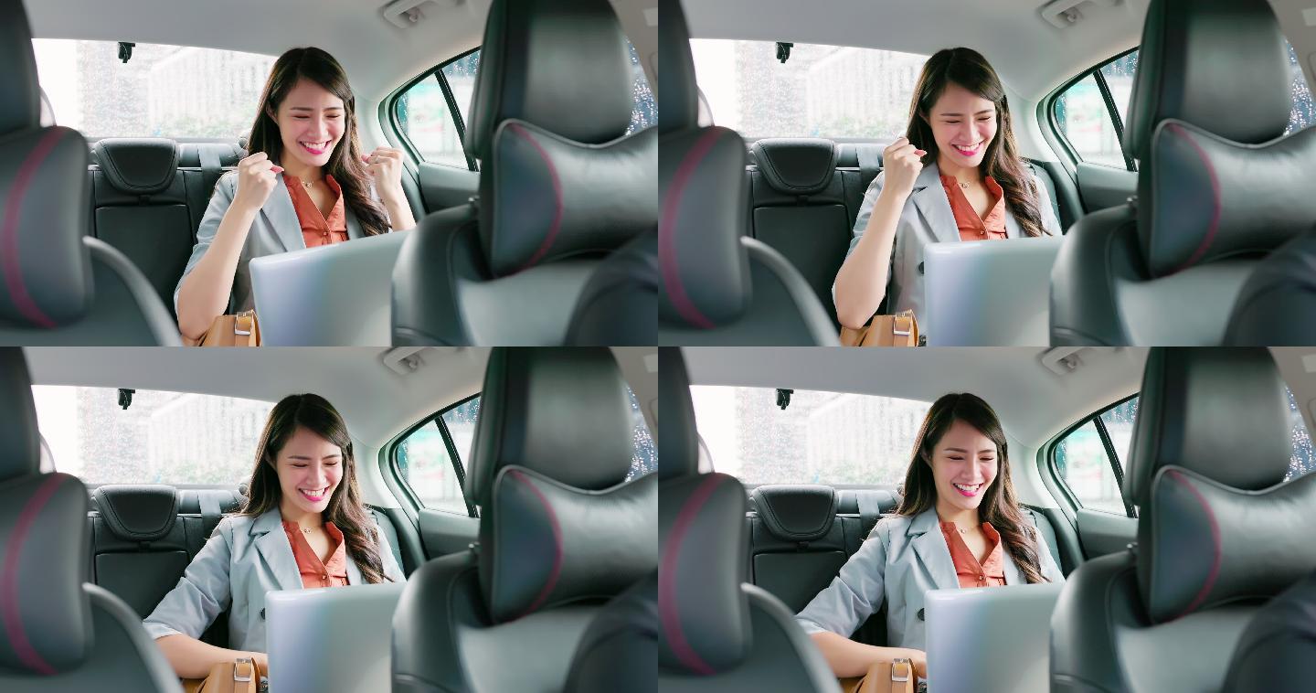 女商人在出租车上使用笔记本电脑