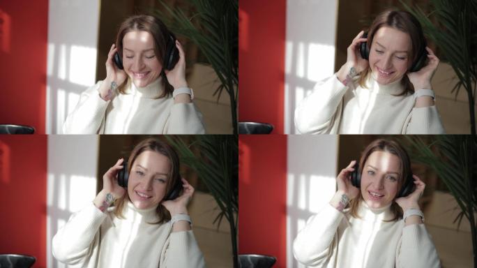 一名金发女子用蓝牙耳机听音乐的特写镜头