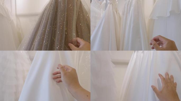 第一人称查看准新娘客户在婚礼当天的婚纱店手摸检查寻找完美的婚纱礼服