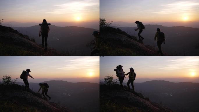 两个徒步旅行者在登山小道上帮助登上山顶