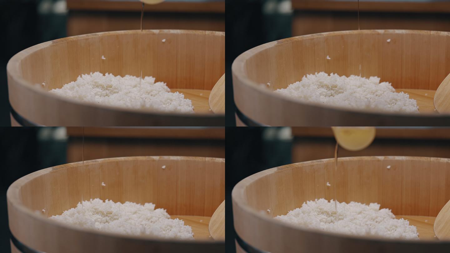 日本寿司厨师将米林倒在Hangiri木碗里的寿司米饭上