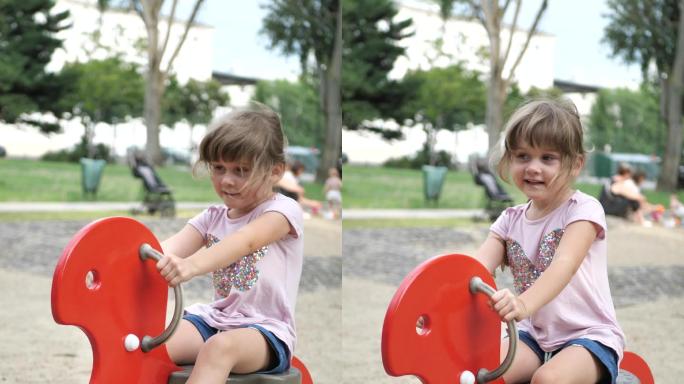 四岁的女孩在公园的操场上玩耍