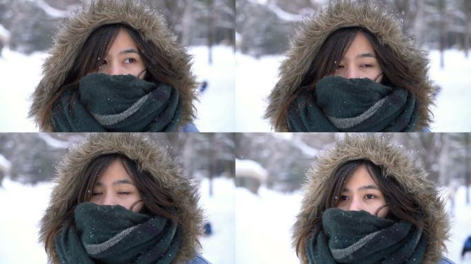 日本北海道札幌丸山公园，年轻的亚洲女人在下雪