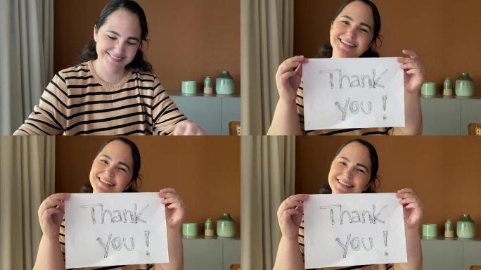 成熟女性展示书面“谢谢”的论文-网络摄像头视角