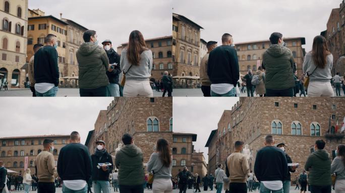 斯洛·莫（SLO MO）导游与一小群游客谈论市政厅维奇奥宫（Palazzo Vecchio）的景点