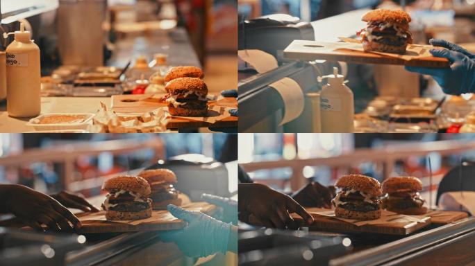一名厨师为服务员为顾客提供汉堡餐的4k视频片段