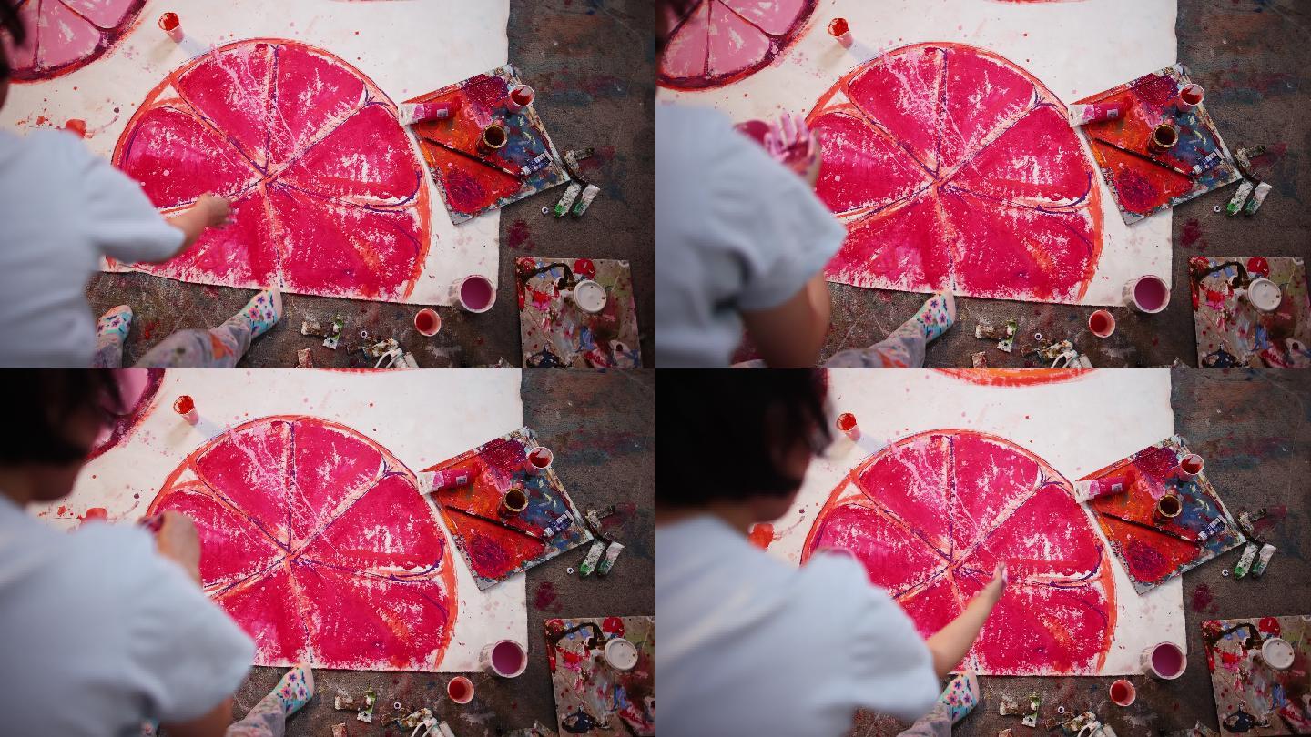 高加索女画家用紫色颜料在画布上绘画的高角度视图