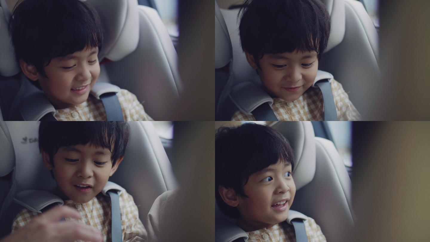 儿童安全汽车座椅上的亚洲男孩。