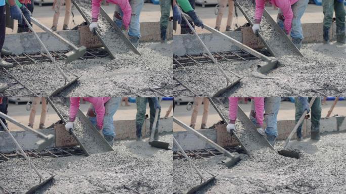 一名亚洲人通过一台倒在地板上的泵送混凝土。
