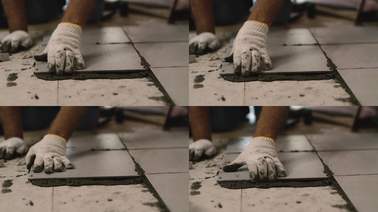 建筑工人铺瓷砖地板。