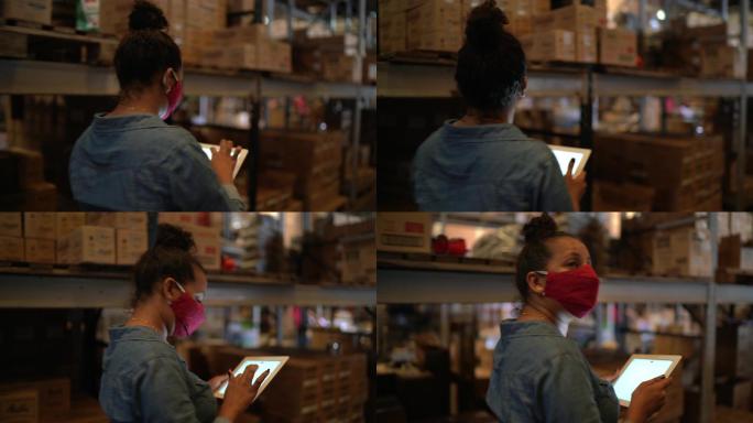 一名戴口罩的年轻女子在配送仓库的质量控制中工作