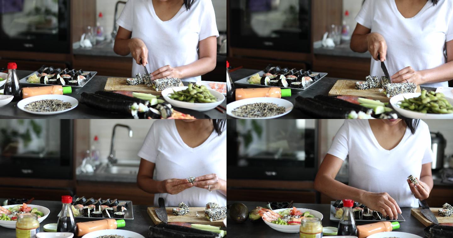 女寿司厨师将由内而外的寿司卷在砧板上切成一小块，然后放在盘子上