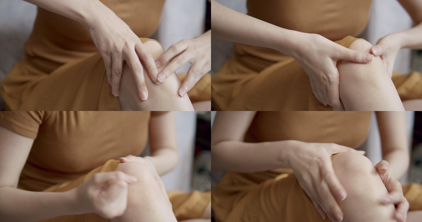近距离4k分辨率拍摄的亚洲女性在家客厅用手按摩他的膝盖疼痛和感觉不好。游戏中的按摩疗法和运动中的损伤