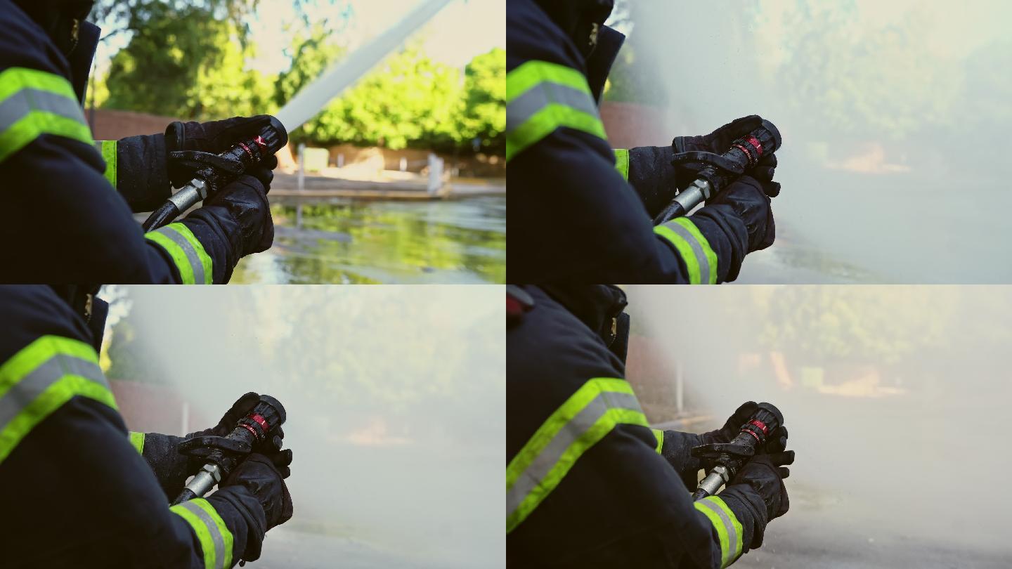 男消防员调整消防水带喷射位置