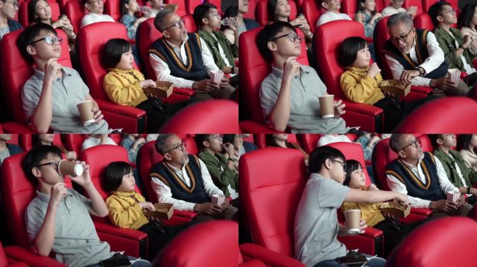 亚裔中国爷爷和孙子喜欢在电影院看电影。