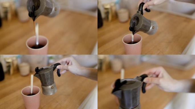 一个人将咖啡从莫卡壶倒入杯子的手