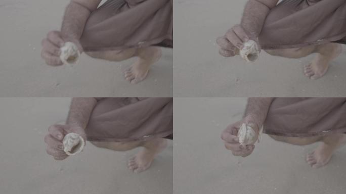 原始人捡沙滩里的贝壳