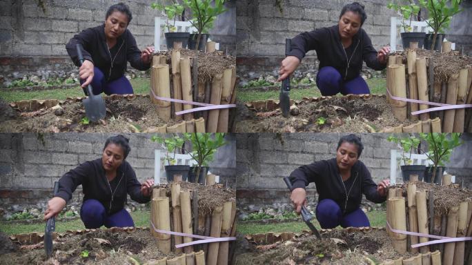 东南亚妇女在家里堆肥有机废物