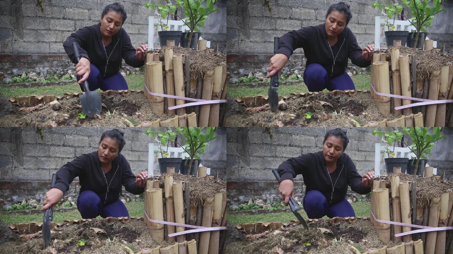 东南亚妇女在家里堆肥有机废物