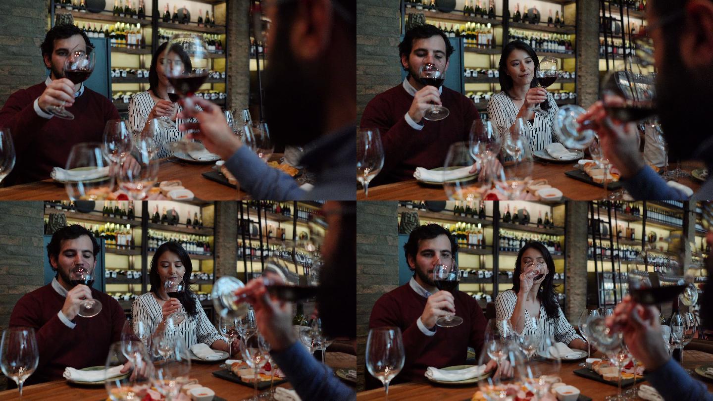 一对拉丁美洲夫妇在品酒会上一边谈笑一边品尝葡萄酒