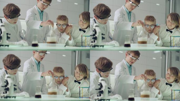 好奇的男孩在做科学实验。实验室内部，沸腾，泡沫液体