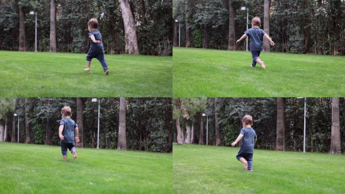 在温暖阳光明媚的夏日里，男婴赤脚在新鲜的绿草上奔跑。侧视图。外部的第一步