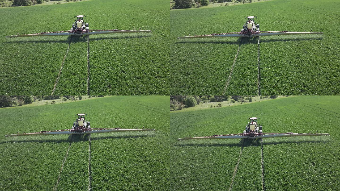 拖拉机为绿色小麦耕地施肥的鸟瞰图。