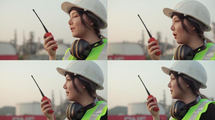 亚洲女工程师通过无线电通话控制施工作业。