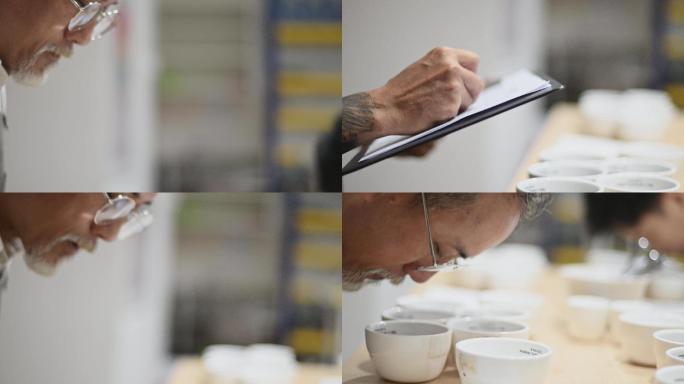 专业高级亚裔华人男咖啡师品级师在咖啡杯上弯腰近距离闻咖啡