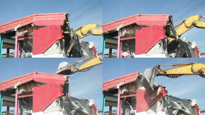 挖掘机拆除建筑物屋顶和墙壁