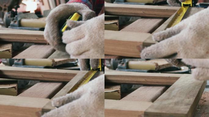高加索木工白色工作木材。木匠正在用卷尺测量木材的尺寸。