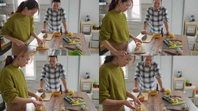 熟练的日本女性切割鲑鱼寿司卷