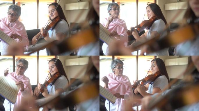 小提琴老师教一个高中女生拉小提琴
