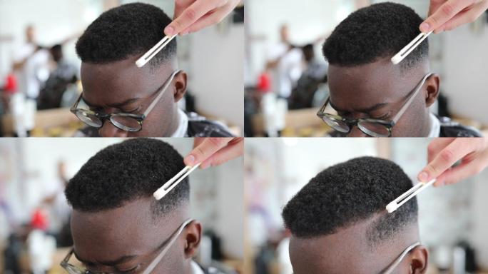 年轻的非洲裔美国男子正在接受现代发型