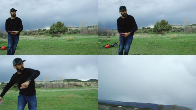 日落时分，一名30多岁留着胡子的高加索男子正手将一名紫色圆盘高尔夫球手抛过雨云下树木覆盖的户外区域（